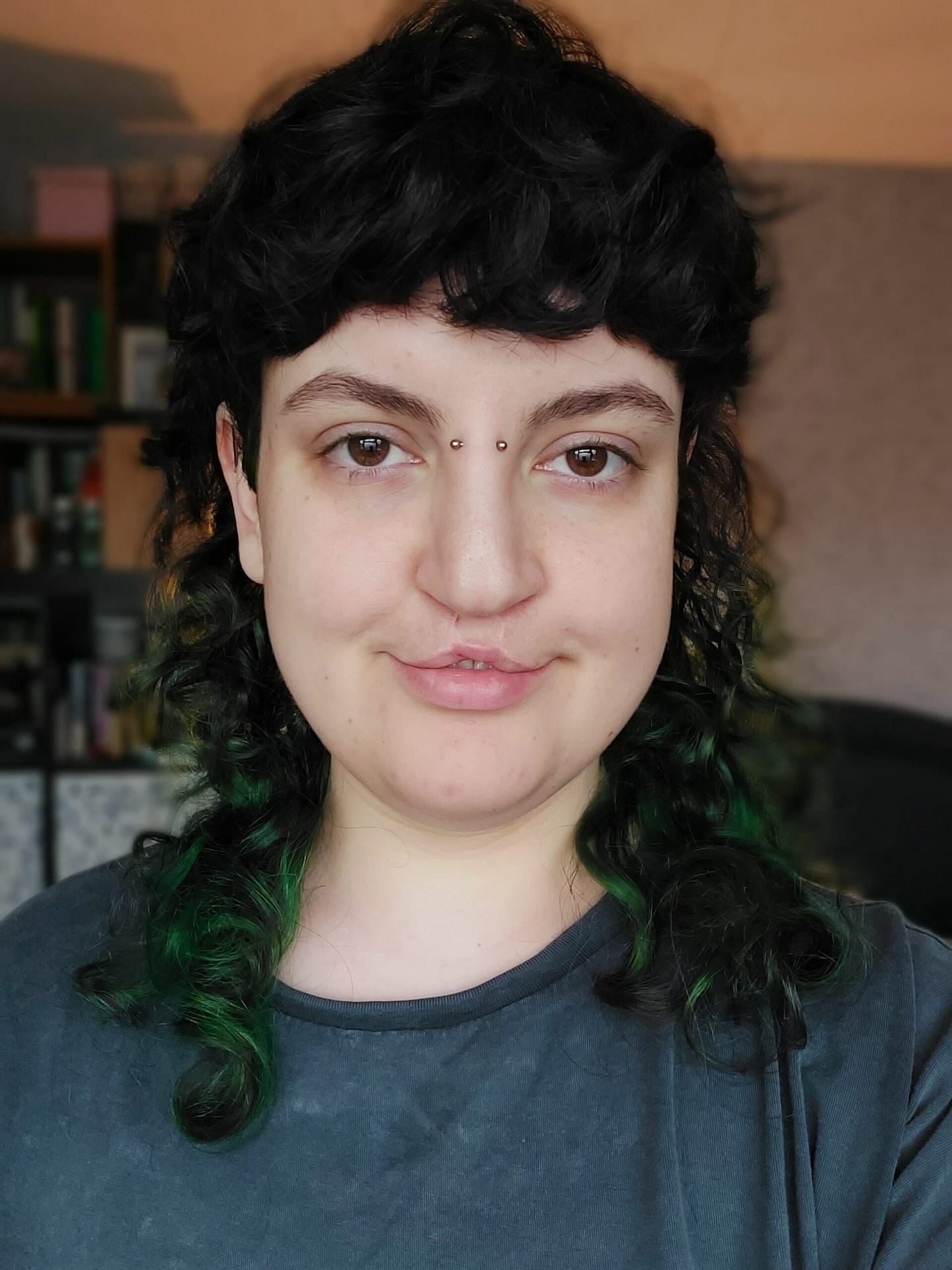 Eloise has long dark hair and is wearing a dark t-shirt