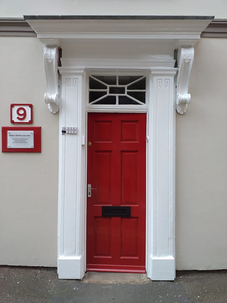 Contact Baines-Ball & Associates red door with white surround