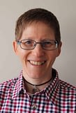 Luan Baines-Ball Counselling and psychotherapy
Luan has short light brown hair and is wearing blue glasses and a navy red white check shirt